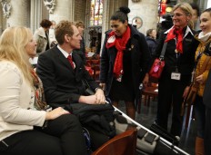Airport worker Geoffroy Lemaitre, who was injured in the bombing, talks to fellow airport workers prior to the start of an ecumenical service for the victims of the Brussels bomb attacks at the Cathedral of St. Michael and St. Gudula in Brussels, Monday, March, 28, 2016.  The Belgian Health Minister Minister Maggie De Block says four of those wounded in the suicide bombings last week have died in the hospital, bringing the number of victims of the bombings to 35. 