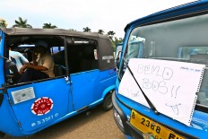 Thousands of Jakarta taxi units and Bajaj parked at Monument Nasional [Monas] while the drivers protest against ride-hailing app in front of the Istana Merdeka, Jakarta, Monday (03/14/2016). During the action they demanded the closure of application service company like Uber, Grab and Gojek. Their presence are illegal as transportation public operating because they have no license as it and have contributed to the decrease of the conventional transportation drivers'income .