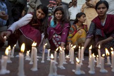 Members of a civil society group light candles during a vigil for the victims of Sunday's suicide bombing, Monday, March 28, 2016 in Karachi, Pakistan. Pakistan's prime minister vowed to eliminate perpetrators of terror attacks such as the massive suicide bombing that targeted Christians gathered for Easter the previous day in the eastern city of Lahore, killing tens of people. 