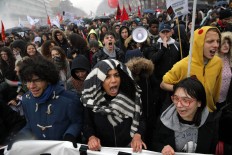 Students shout slogans during a demonstration in Paris, Thursday, March 31, 2016. Some French train drivers, teachers and others are on strike to reject a government reform relaxing the 35-hour workweek and other labor rules. The strike is not affecting Paris' Charles de Gaulle airport, but 20 percent of flights at Paris' Orly airport have been canceled. AP/Christophe Ena