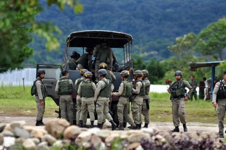 Several members of Police' Mobile Brigade get on a vehicle to get to Sedoa Village, North Lore subdistrict in Poso of Central Sulawesi on March. 24. The police personnel are part of the joint Tinombala Operation to capture Indonesia's most wanted terrorist Santoso and his followers of East Indonesia Mujahidin radical group.