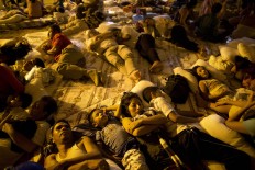 Residents sleep under a makeshift tent  outside the emergency center in the town of Portoviejo, Ecuador, Sunday, April 17, 2016. Parts of Ecuador have been devastated by the country's strongest earthquake in decades, as the death toll continues to rise and people left homeless prepare to sleep outside for second straight night. AP Photo/Rodrigo Abd