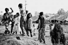 Children play around their temporary shelter, Ratna Park, May 1, 2015. JP/ Ayomi Amindoni