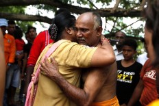 A participant receives a blessing from relative before piercing his cheeks. JP/ Hotli Simanjuntak
