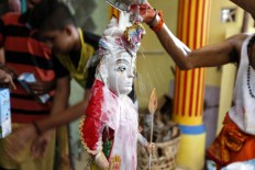 A statue is bathed in milk as the priests complete the Panguni Uthiram ritual. JP/ Hotli Simanjuntak