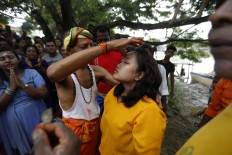 An incantation is made before piercing tongues and cheeks. JP/ Hotli Simanjuntak
