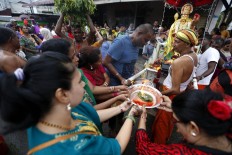 Devotees present offerings to the statue of Lord Murugan in front of the temple at the end of the Panguni Unthiram parade. JP/ Hotli Simanjuntak