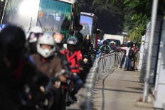 Alfini began to block a group of motorcycle attempting to avoid traffic by trespassing on a sidewalk on Monday. She took action to protest unruly bikers. The Jakarta Post/ Dhoni Setiawan