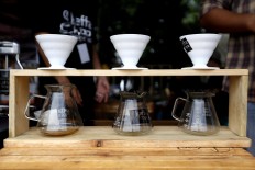A coffee shop barista demonstrates how to serve coffee using a pour-over-brewing technique. JP/ Hotli Simanjuntak