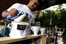 A coffee shop barista demonstrates how to prepare coffee using the pour-over-brewing technique with a V60 coffee maker. The technique aims to prepare coffee and serve the coffee while maintaining its most original flavor. JP/ Hotli Simanjuntak