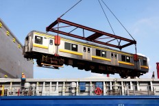A train car is unloaded at the Tanjung Priok Port in North Jakarta on Dec. 5, 2014. KAI Commuter Jabodetabek [KCJ], the operator of the Greater Jakarta commuter line, received 16 train cars from Japan in the final shipment of the 2014 train procurement program, in which the company received a total of 176 train cars. JP/Seto Wardhana