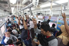 Due to limited seating space, it is not uncommon for passengers to stand, as seen on a train heading to Tanah Abang Station on Sept. 4, 2015. JP/Dhoni Setiawan