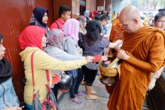 Muslim residents give alms to the priests. JP/Tarko Sudiarno