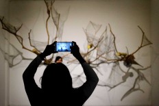 A display at ARTJOG 2016 is used as a backdrop by young visitors taking pictures.
