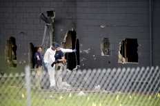 Police officials investigate the back of the Pulse nightclub after a shooting involving multiple fatalities at the nightclub in Orlando, Fla., Sunday, June 12, 2016. AP Photo/Phelan M. Ebenhack

