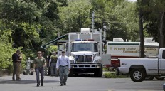 Law enforcement officials check an apartment complex possibly linked to the fatal shooting at an Orlando nightclub, Sunday, June 12, 2016, in Fort Pierce, Fla. AP Photo/Alan Diaz
