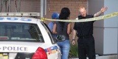 An Orlando police officer directs friends of victims of the shooting at Pulse nightclub, where a mass shooting occured, outside the emergency room at Orlando Regional Medical Center, Sunday, June 12, 2016. A gunman wielding an assault-type rifle and a handgun opened fire inside a crowded gay nightclub early Sunday, before dying in a gunfight with SWAT officers, police said. It was the worst mass shooting in American history.  Joe Burbank/Orlando Sentinel via AP