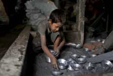 In this Sunday, June 12, 2016, photo, Ridoy, 7, works at a factory that makes metal utensils in Dhaka, Bangladesh. AP Photo/ A.M. Ahad