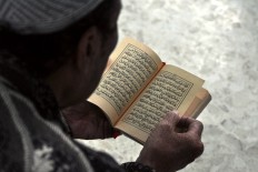 A man recites the Quran while waiting to break the fast. JP/ Albertus Magnus Kus Hendratmo