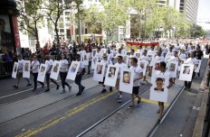 Marchers hold pictures of victims of the Orlando nightclub shooting during the San Francisco Gay Pride parade Sunday, June 26, 2016, in San Francisco. Parades in San Francisco and other major cities Sunday featured increased security, anti-violence messages and tributes to those killed in this month's massacre at a gay nightclub in Florida. AP Photo/Marcio Jose Sanchez