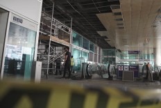 Construction workers repair the damaged walls and windows at the blast site at Ataturk Airport in Istanbul, Wednesday, June 29, 2016. AP Photo/Bram Janssen