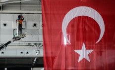 A worker wipes traces of blood from the wall of Ataturk Airport in Istanbul, Wednesday, June 29, 2016. AP Photo/Omer Kuscu