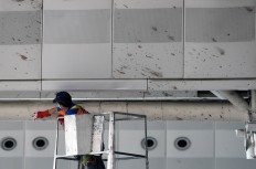 A worker wipes traces of blood from the wall of Ataturk Airport in Istanbul, Wednesday, June 29, 2016. AP Photo/Omer Kuscu