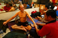 An actor gets a relaxing massage before the show begins. Some of the actors are a new generation in the troupe. JP/ Wienda Parwitasari