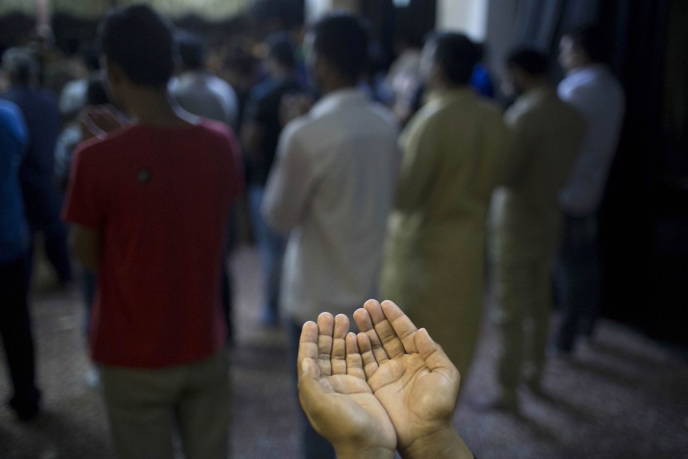 Sunni Muslims living in Greece pray on the first day of Eid al-Fitr prayers in Piraeus near Athens, Wednesday, July. 6, 2016. Muslims worldwide are celebrating Eid al-Fitr, marking the end of the Muslim holy fasting month of Ramadan. AP Photo/Petros Giannakouris