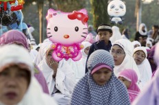 Muslims pray during morning prayer for Eid al-Fitr, marking the end of the holy month of Ramadan, at the National Mosque in Kuala Lumpur, Malaysia, Wednesday, July 6, 2016. AP Photo/Vincent Thian
