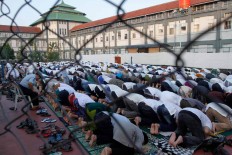 Hundreds of inmates and staff members join in Idul Fitri prayers at the Sukamiskin prison in West Java on Wednesday. The government has promised to grant special remission to 49 corruption convicts provided they fully pay their fines and return illegally obtained money, as ordered in their sentences. JP/ Arya Dipa
