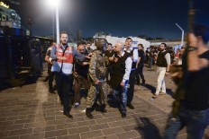 A Turkish police officer, right, confronts a Turkish army officer, left, that participated in the coup, after he was apprehended in Istanbul's Taksim square, early Saturday, July 16, 2016.  Turkish President Recep Tayyip Erdogan told the nation Saturday that his government was working to crush a coup attempt after a night of explosions, air battles and gunfire across the capital. AP Photo/Selcuk Samiloglu