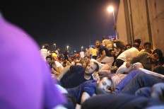 People protesting against the coup, try to protect themselves during a firefight between police and army forces in Istanbul, early Saturday, July 16, 2016. Turkish President Recep Tayyip Erdogan told the nation Saturday that his government was working to crush a coup attempt after a night of explosions, air battles and gunfire across the capital. Officials said the coup appeared to have failed as Turks took to the streets overnight to confront troops attempting to take over the country. AP Photo/Omer Kuscu