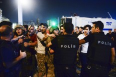 Turkish soldiers, arrested by civilians, are handed to police officers, in Istanbul's Taksim square, early Saturday, July 16, 2016. Members of Turkey's armed forces said they had taken control of the country, but Turkish officials said the coup attempt had been repelled early Saturday morning in a night of violence, according to state-run media. AP Photo/Selcuk Samiloglu