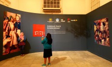 A visitor poses for a picture at the State Palace painting exhibition held at the National Gallery in Jakarta, on Aug. 2. The Jakarta Post/Wienda Parwitasari