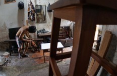 Lie Cie Sieng is a carpenter who lives in the communal house. JP/ Tarko Sudiarno
                  