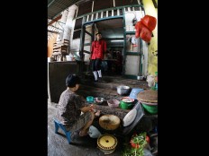 Gepeng, a young man who cares about his kampung, wears a Chinese traditional costume. JP/ Tarko Sudiarno