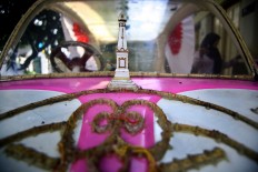A miniature of Tugu, Yogyakarta’s iconic monument, is put on a pink pedal car for the carnival. JP/ Aditya Sagita