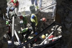 Rescuers search for survivors through rubble after an earthquake, in Accumoli, central Italy, Wednesday, Aug. 24, 2016. A devastating earthquake rocked central Italy early Wednesday, collapsing homes on top of residents as they slept. At least 23 
people were reported dead in three hard-hit towns where rescue crews raced to dig survivors out of the rubble, but the toll was expected to rise as crews reached homes in more remote hamlets. AP Photo/Andrew Medichini