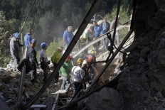 Rescuers search for survivors through rubble after an earthquake, in Accumoli, central Italy, Wednesday, Aug. 24, 2016. A devastating earthquake rocked central Italy early Wednesday, collapsing homes on top of residents as they slept. At least 23 
people were reported dead in three hard-hit towns where rescue crews raced to dig survivors out of the rubble, but the toll was expected to rise as crews reached homes in more remote hamlets. AP Photo/Andrew Medichini