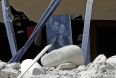 A family photo is seen among the debris of a collapsed house in Accumoli, central Italy, Wednesday, Aug. 24, 2016. The magnitude 6 quake struck at 3:36 a.m. [0136 GMT] and was felt across a broad swath of central Italy, including Rome where 
residents of the capital felt a long swaying followed by aftershocks. AP Photo/Andrew Medichini
