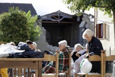 Residents sit outdoor following an earthquake in Cumuli, central Italy, Wednesday, Aug. 24, 2016. A strong earthquake in central Italy reduced three towns to rubble as people slept early Wednesday. The magnitude 6 quake struck at 3:36 a.m. [0136 GMT] and was felt across a broad swath of central Italy, including Rome, where residents felt a long swaying followed by aftershocks. The temblor shook the Lazio region and Umbria and Le Marche on the Adriatic coast. AP Photo/Andrew Medichini