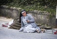A nun checks her mobile phone as she lies near a victim laid on a ladder following an earthquake in Amatrice Italy, Wednesday, Aug. 24, 2016. The magnitude 6 quake struck at 3:36 a.m. [0136 GMT] and was felt across a broad swath of central Italy, including Rome where residents of the capital felt a long swaying followed by aftershocks. Massimo Percossi/ANSA via AP