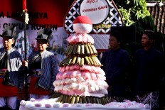 A small mountain made from rice cake [arem-arem] waits to be carried around the kampung. JP/Aditya Sagita