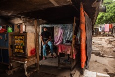 Ratnaningsih, 35, lives alone in her shack, Pejagalan, Jakarta, August 2016. She was born under the toll road but her parents went back to Lamongan, East Java, since the eviction. When business at Kalijodo was robust, she sold snacks and food at her stall. JP/Seto Wardhana