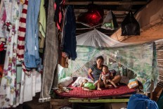 Vivianti, 35, lives with her husband and their twin sons Kevan and Kevin, 2, in the shack under the Tomang-Pluit toll road in Pejagalan. They had been living there since 2010. Before eviction, they sold meatballs but they had their meatball cart destroyed during the eviction. JP/Seto Wardhana

