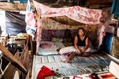 Sumiyati, 52, live with husband Aceng, 55, and granddaughter Yohana, 16, in their shack, Pejagalan, Jakarta, August 2016. She had been living there for 12 years since 2004. Her husband makes a living by becoming an ojek [motorcycle taxi] driver. JP/Seto Wardhana