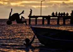 Children play at sunset at Namatota Island’s dock in Kaimana, West Papua. JP/Wendra Ajistyatama