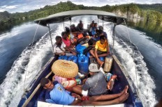 Residents cross Triton's Gulf in a boat, the only mode of transportation available to reach the islands around Kaimana district. JP/Wendra Ajistyatama
