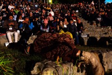 The audience bundles up against the chilly night air in the resort amphitheater amid the surroundings of Bromo Tengger Semeru National Park. JP/ Tarko Sudiarno